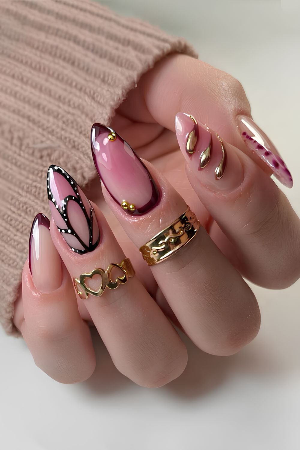 Pink and brown nails with butterfly and metallic details