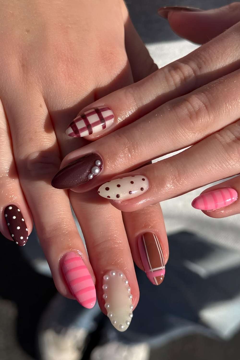 Pink and brown nails with plaid and polka dots