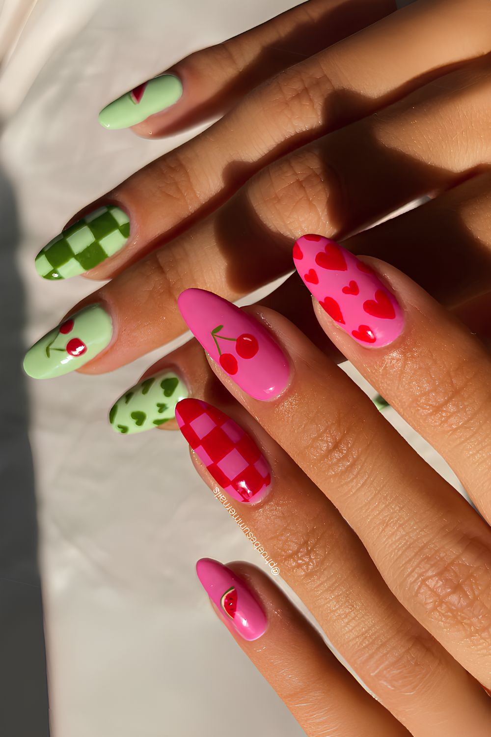 Pink and green nails with cherries and checkerboards
