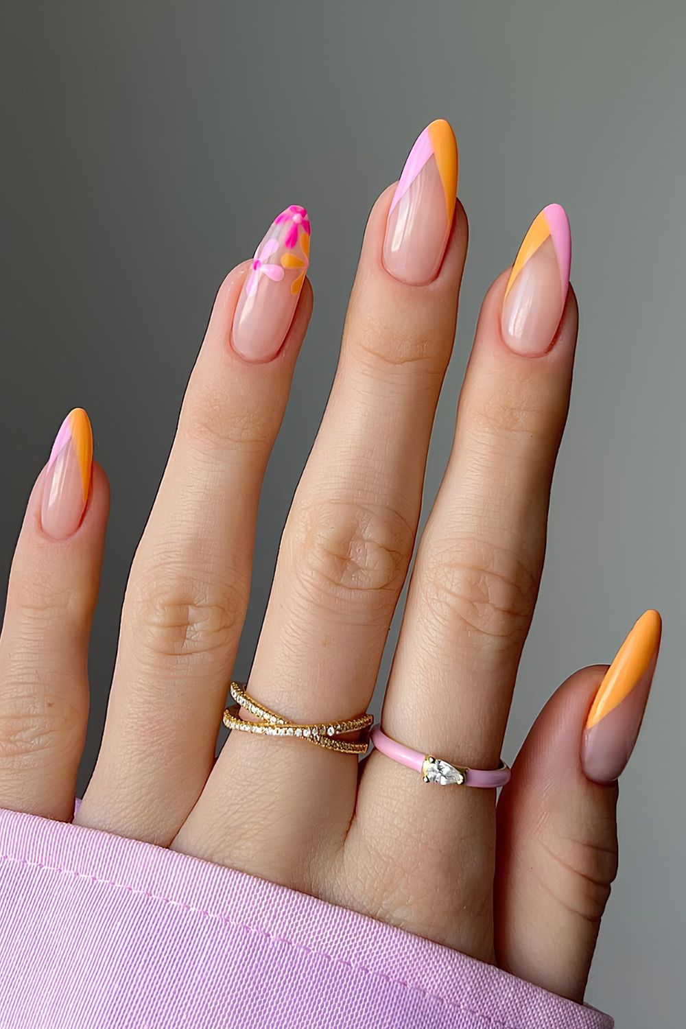 Pink and orange French nails with floral accent