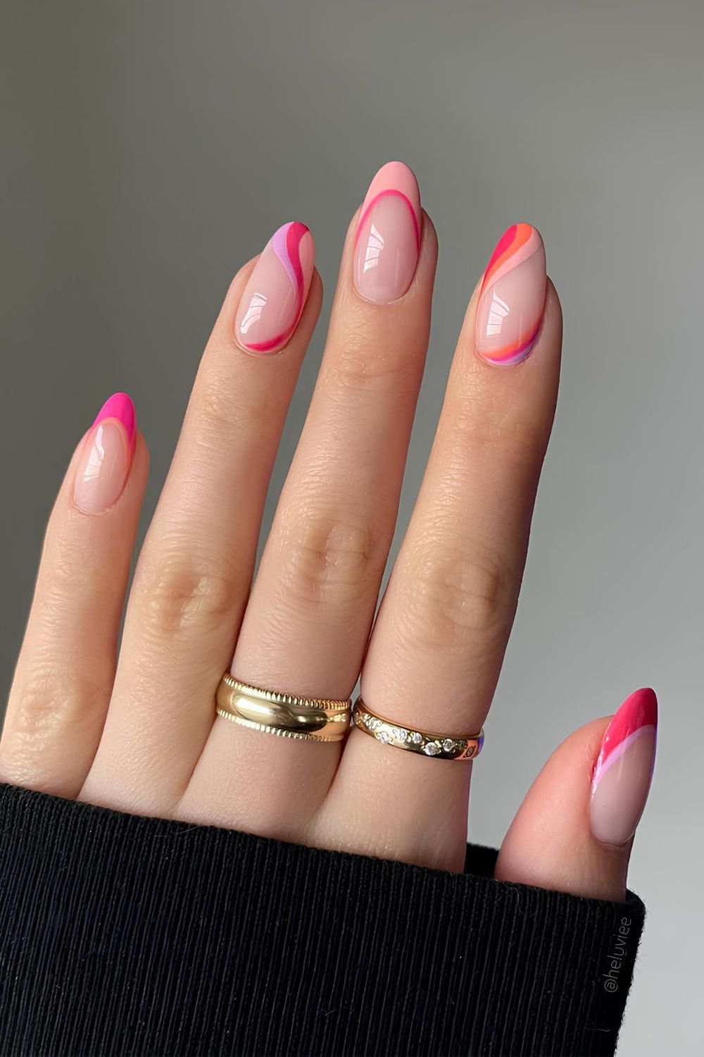 Pink and orange French nails with swirls