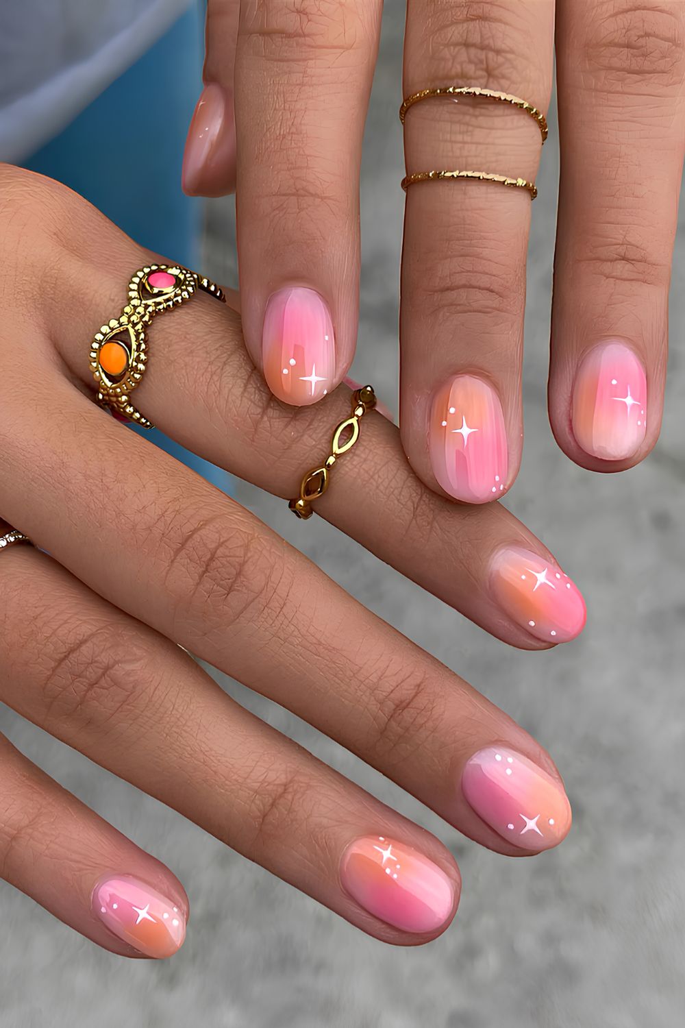 Pink and orange aura nails with celestial art