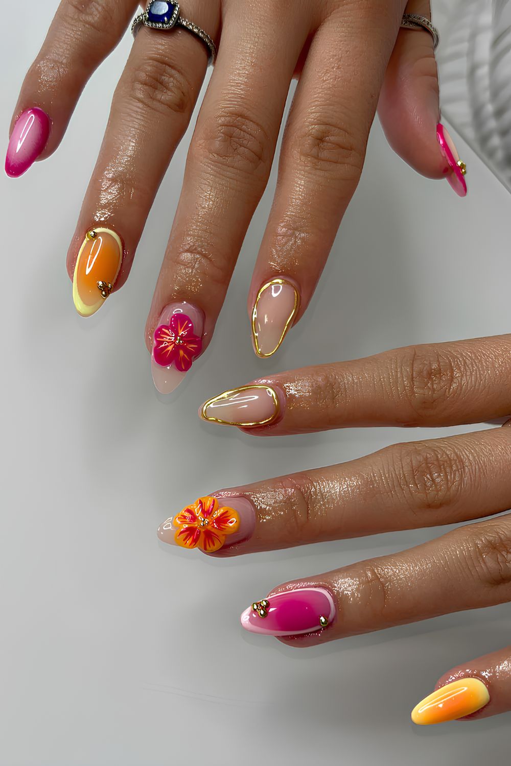 Pink and orange nails with 3d florals and gold chrome details