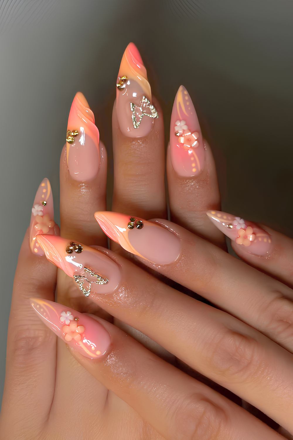Pink and orange nails with flowers and butterflies
