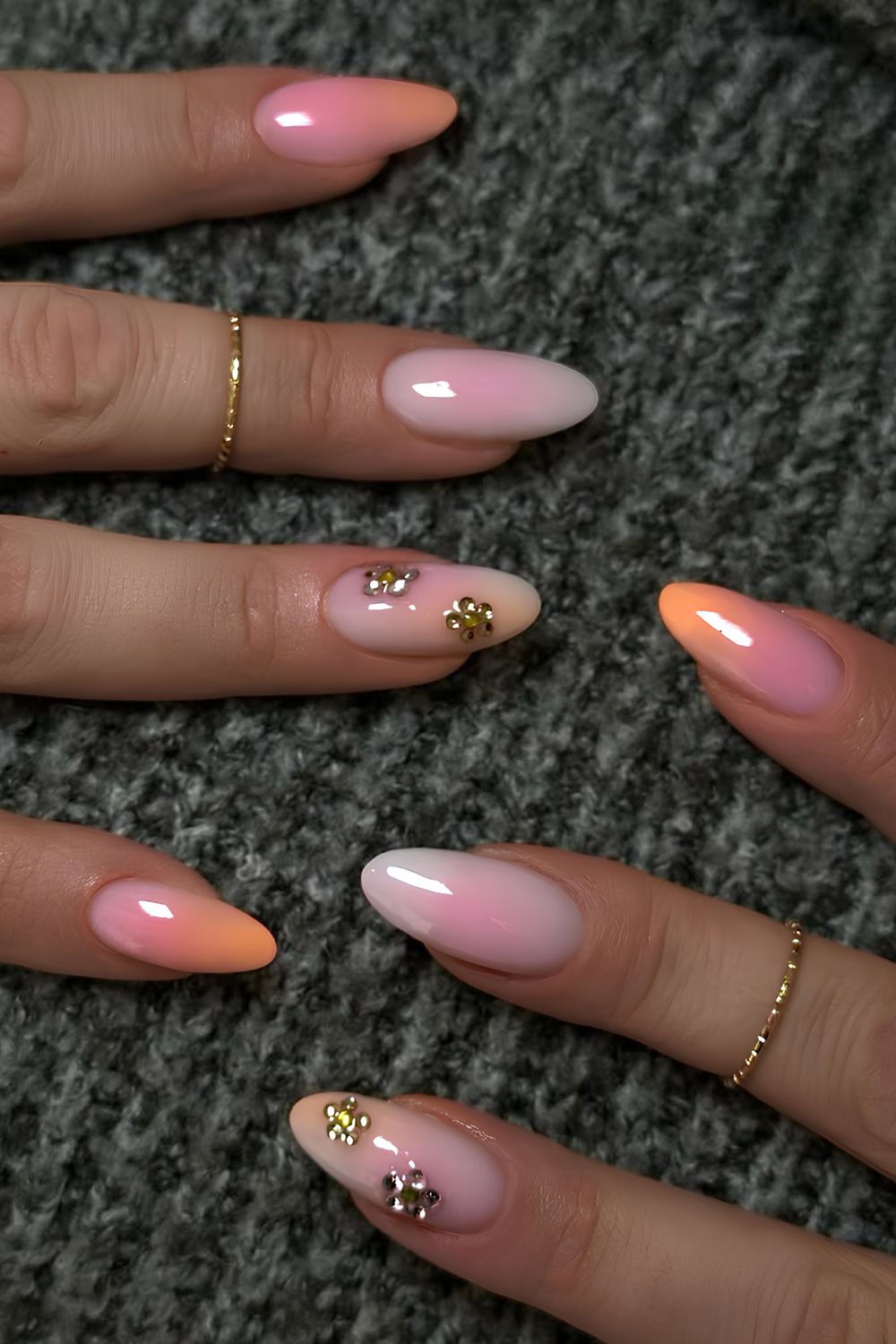 Pink and orange nails with rhinestone accents