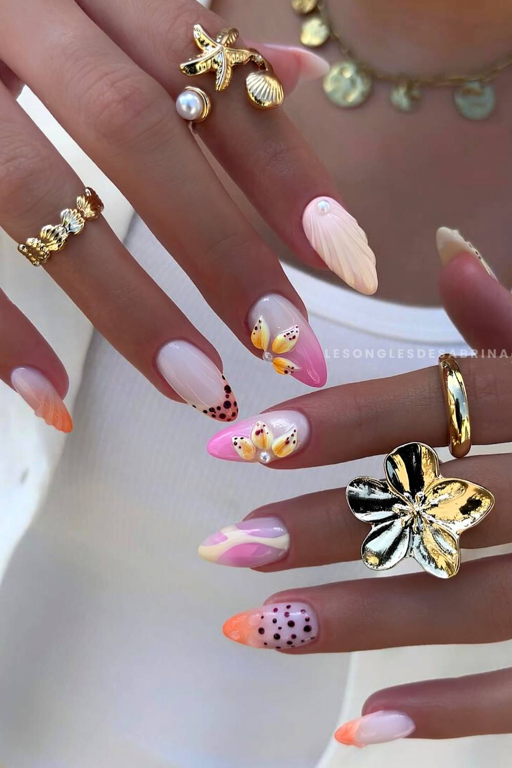 Pink and orange nails with tropical inspired accents