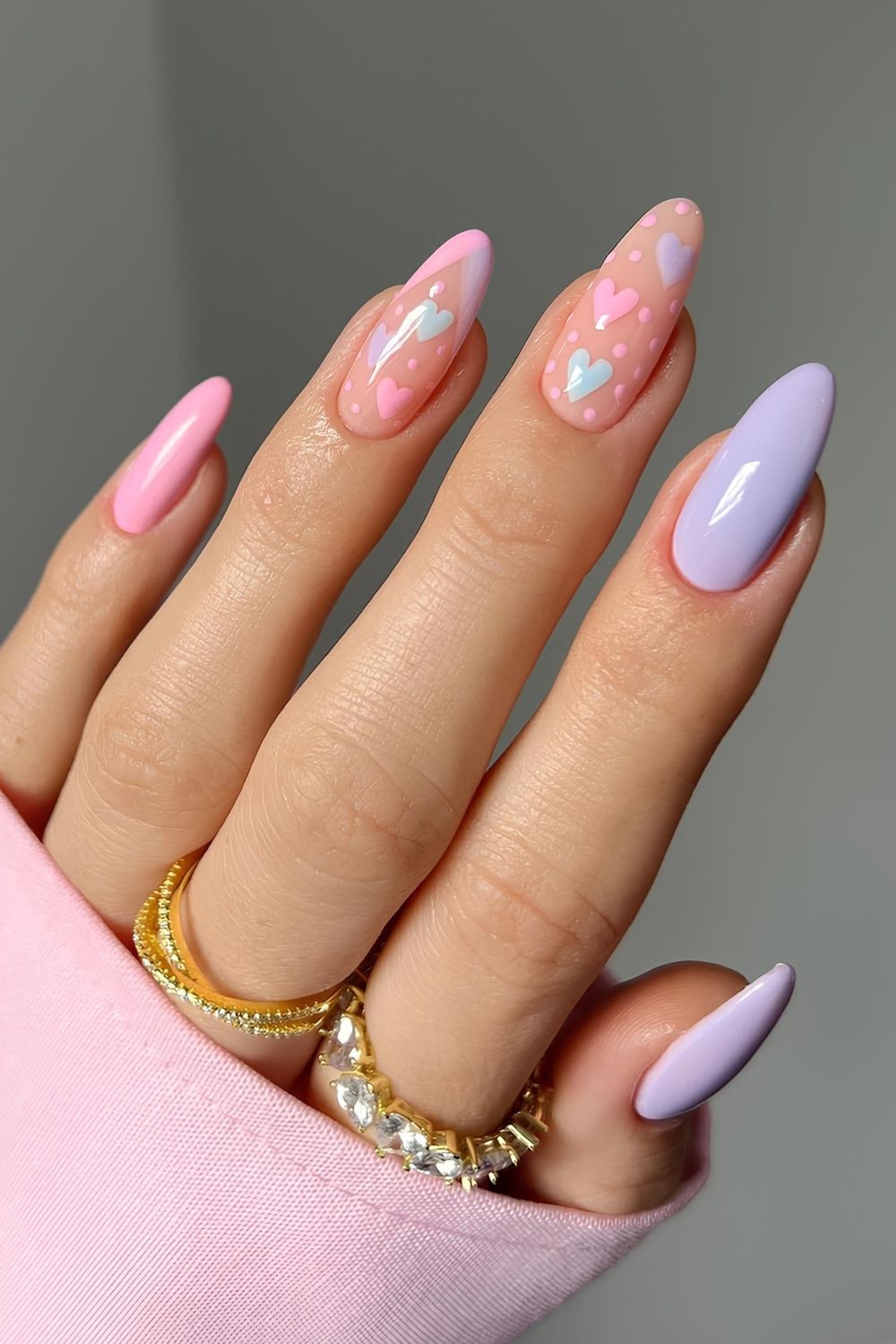 Pink and purple pastel nails with hearts and dots