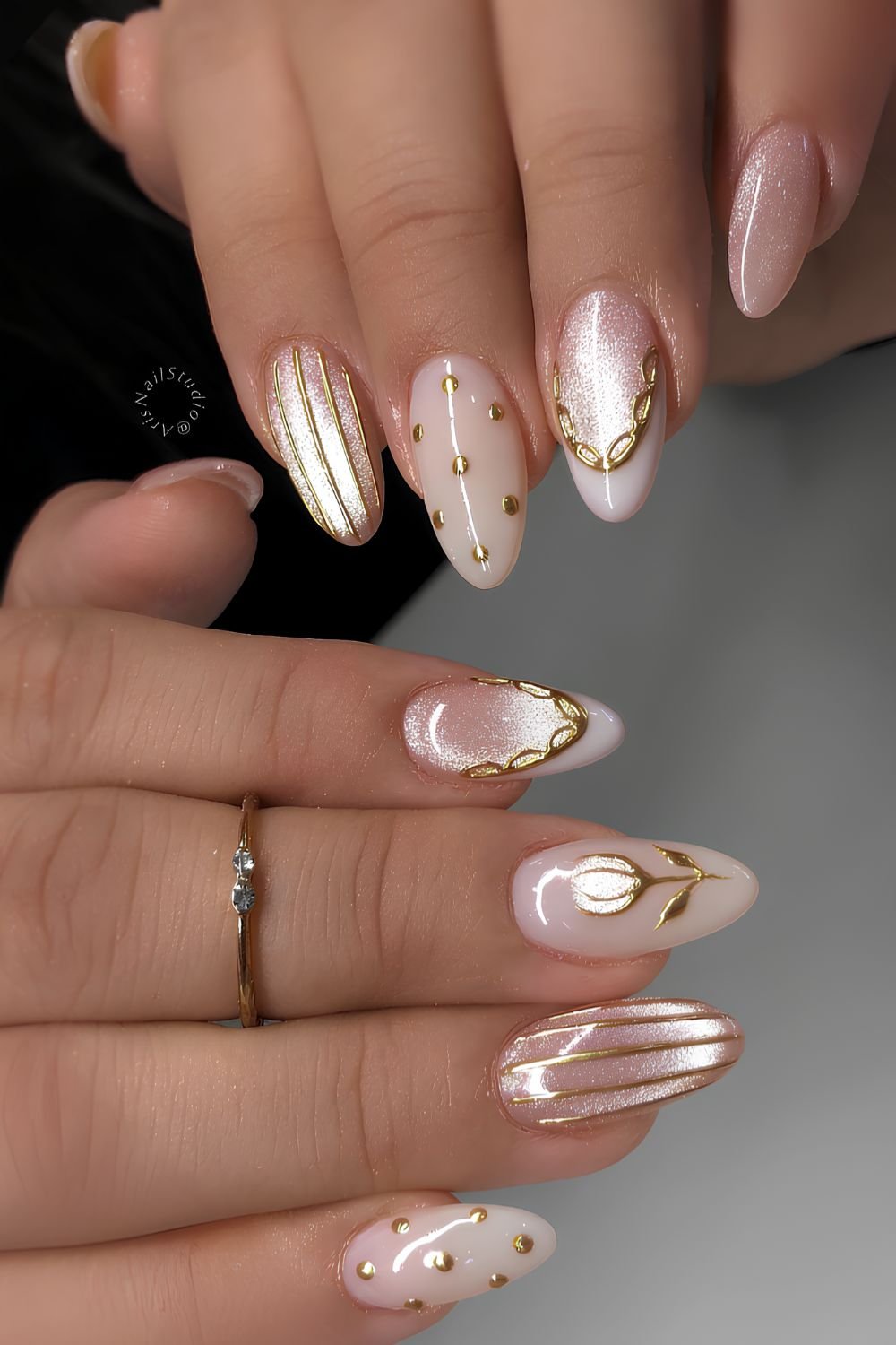 Pink and white cat eye nails with gold details