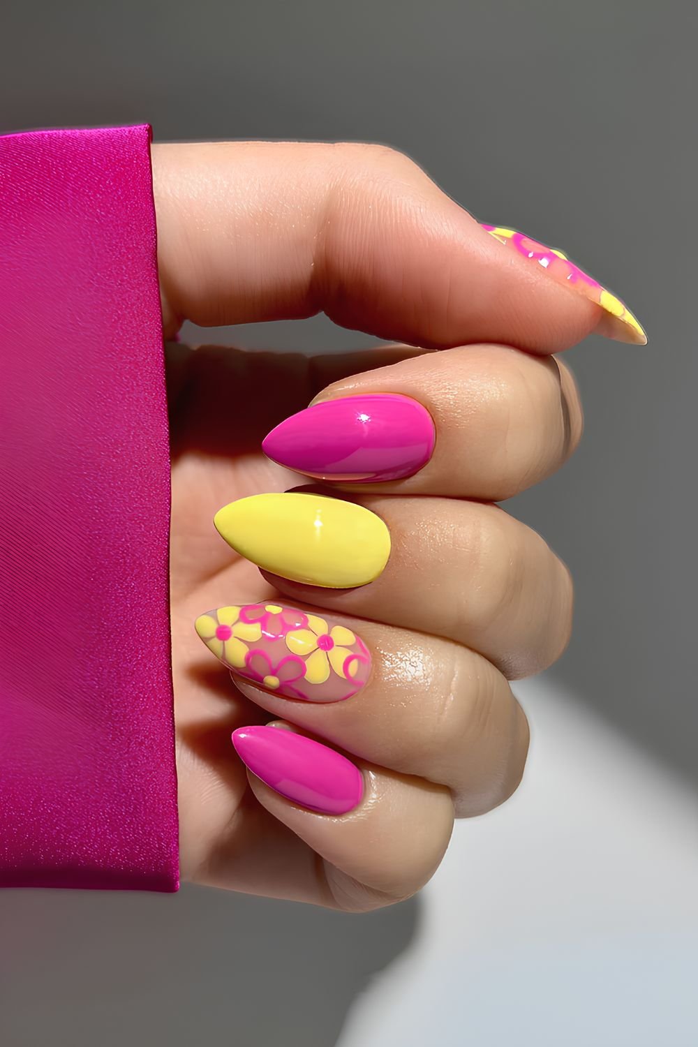 Pink and yellow nails with floral accents
