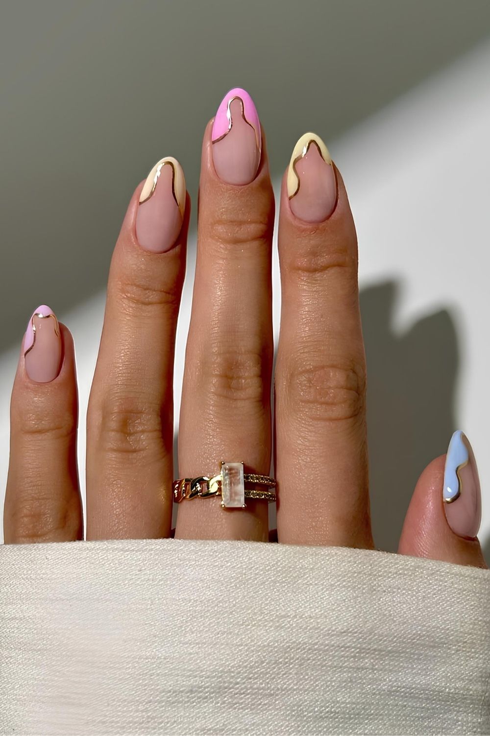 Pink and yellow pastel French abstract nails with gold outline