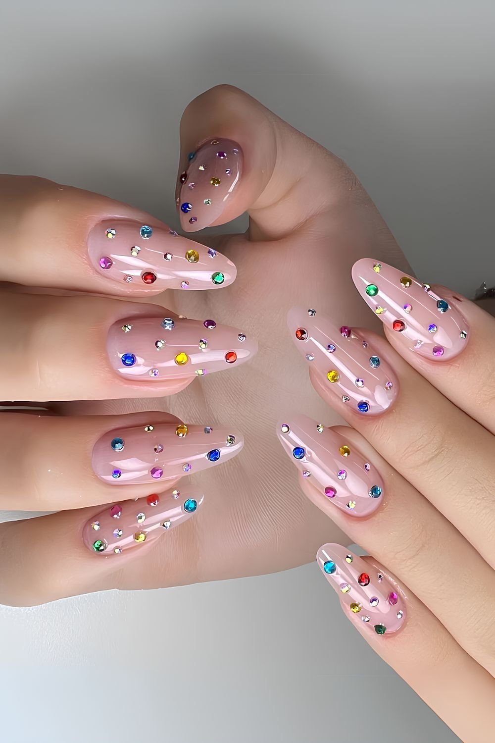 Pink base nails with colorful gems