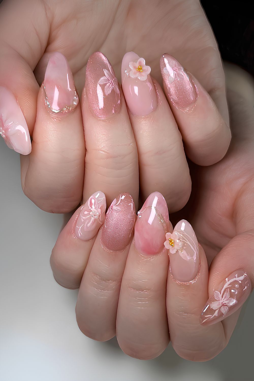 Pink cat eye nails with cherry blossoms