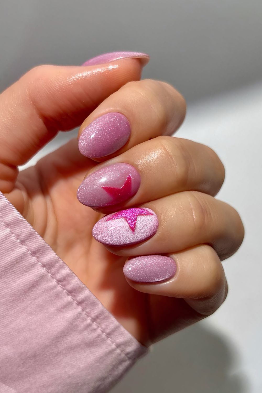 Pink cat eye nails with star accent