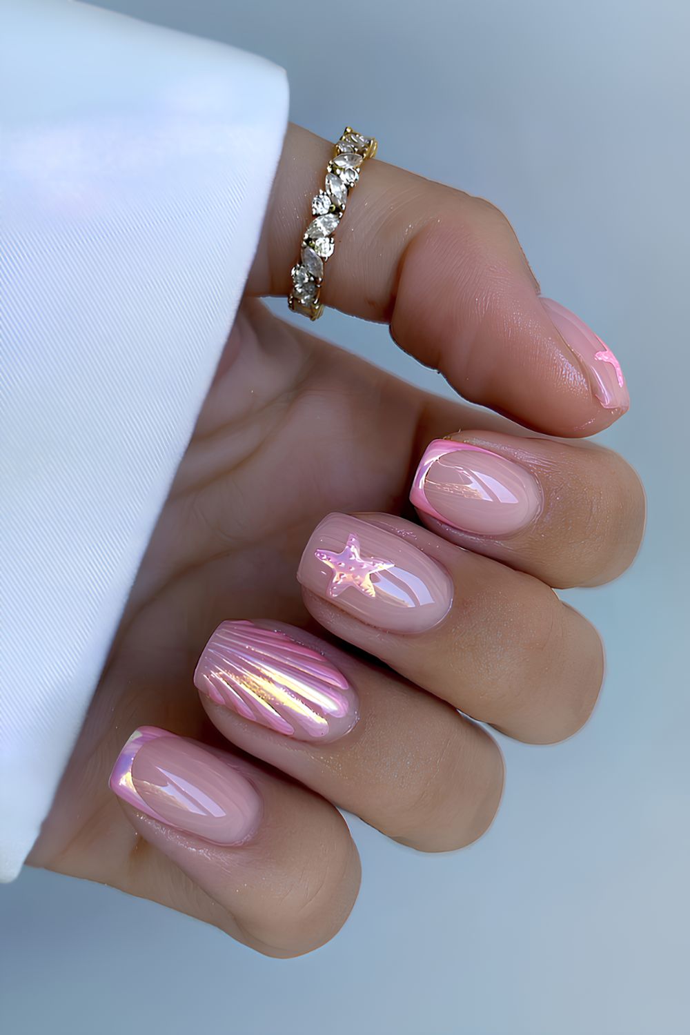 Pink chrome French mani with seashell design