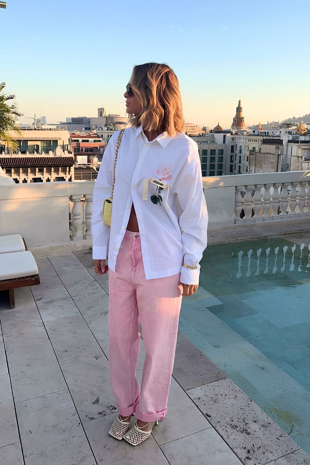 Pink denim trousers with white shirt and sandals