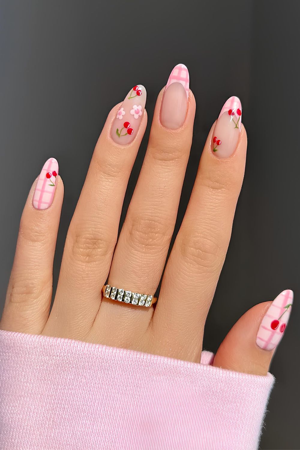 Pink gingham nails with cherry accents