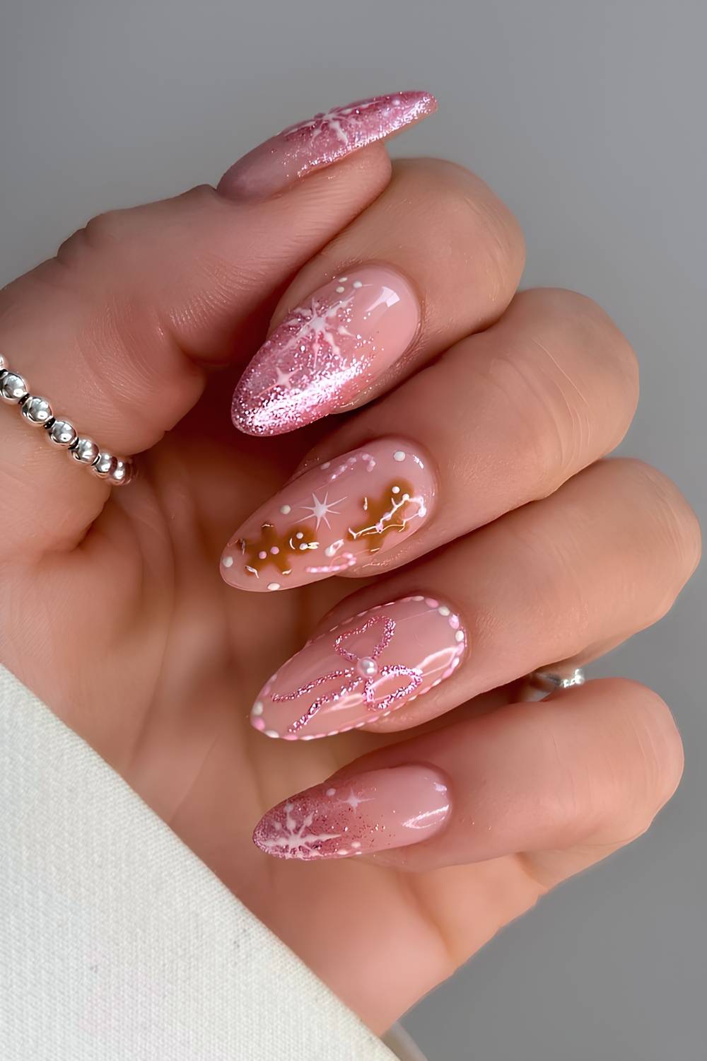 Pink glitter nails with gingerbread and snowflake art