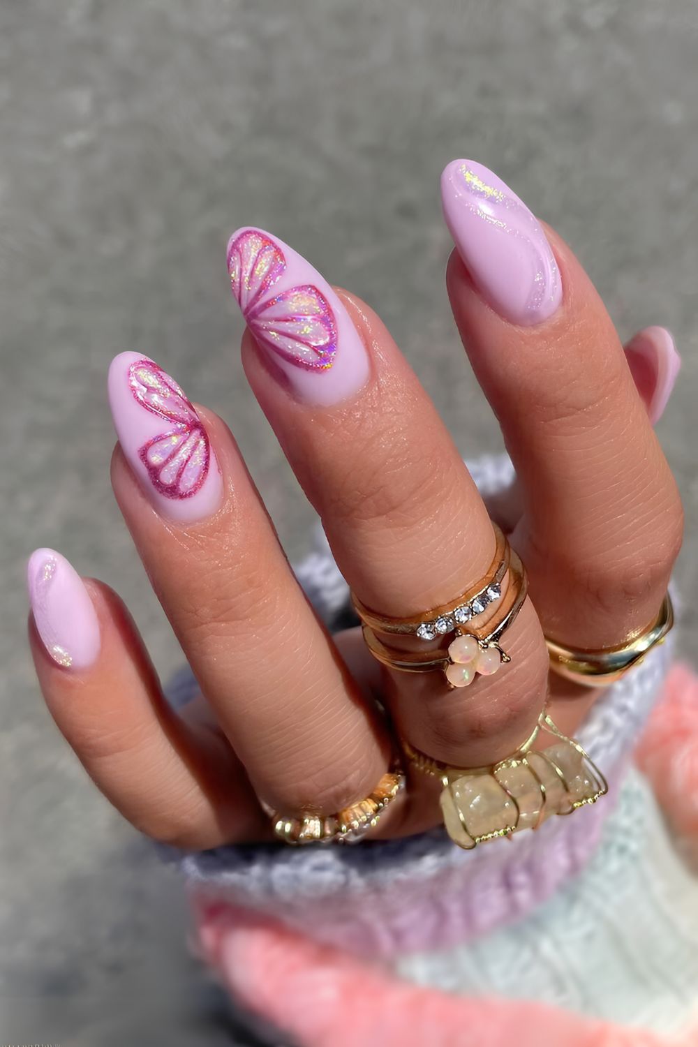 Pink nails with oversized butterfly art