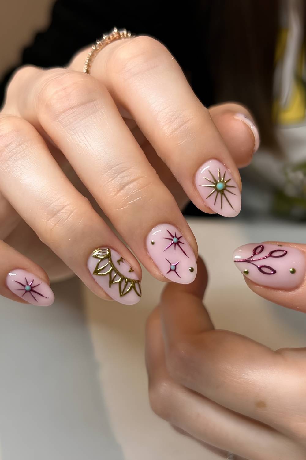 Pink nails with sun and star art