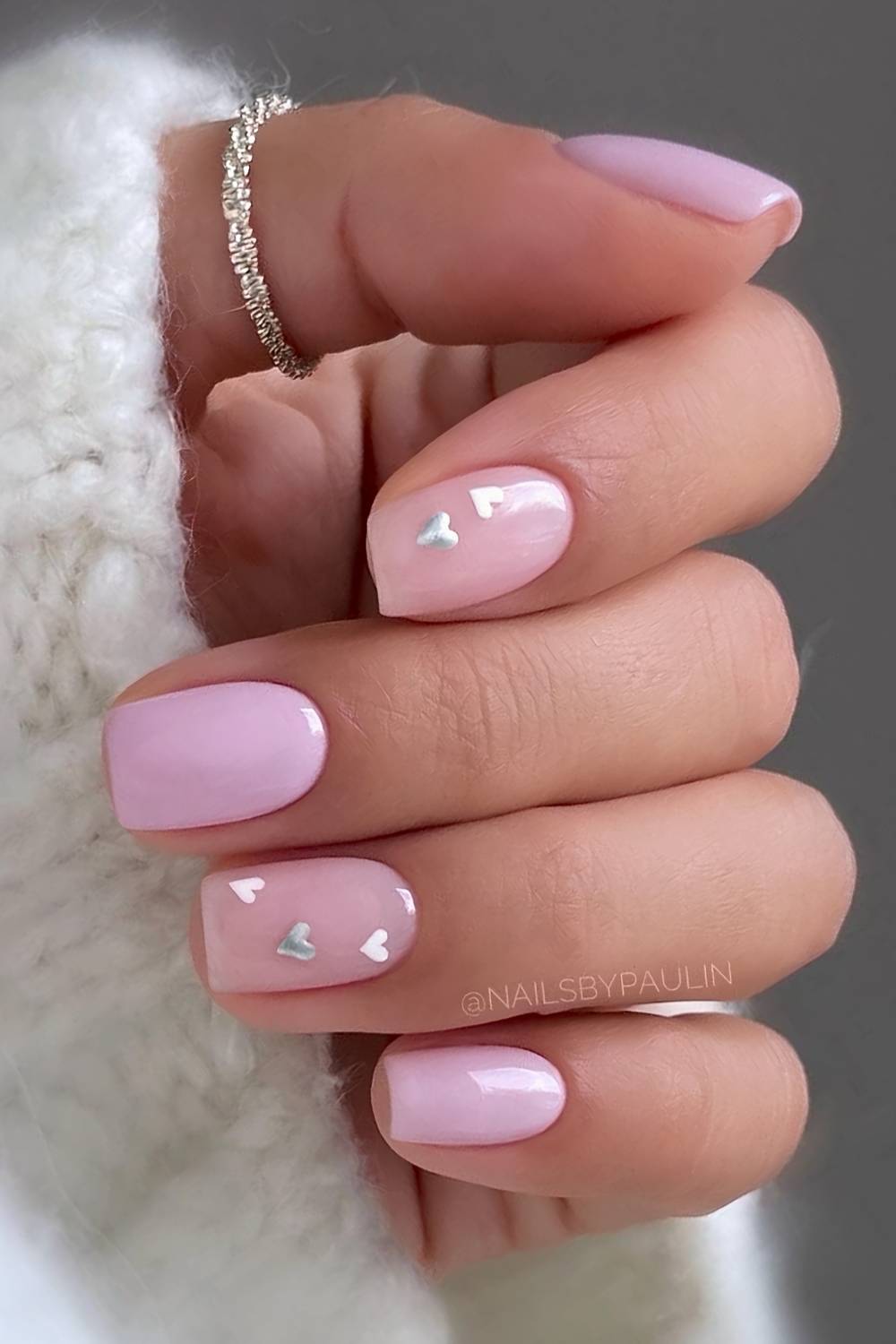 Pink nails with white and silver hearts