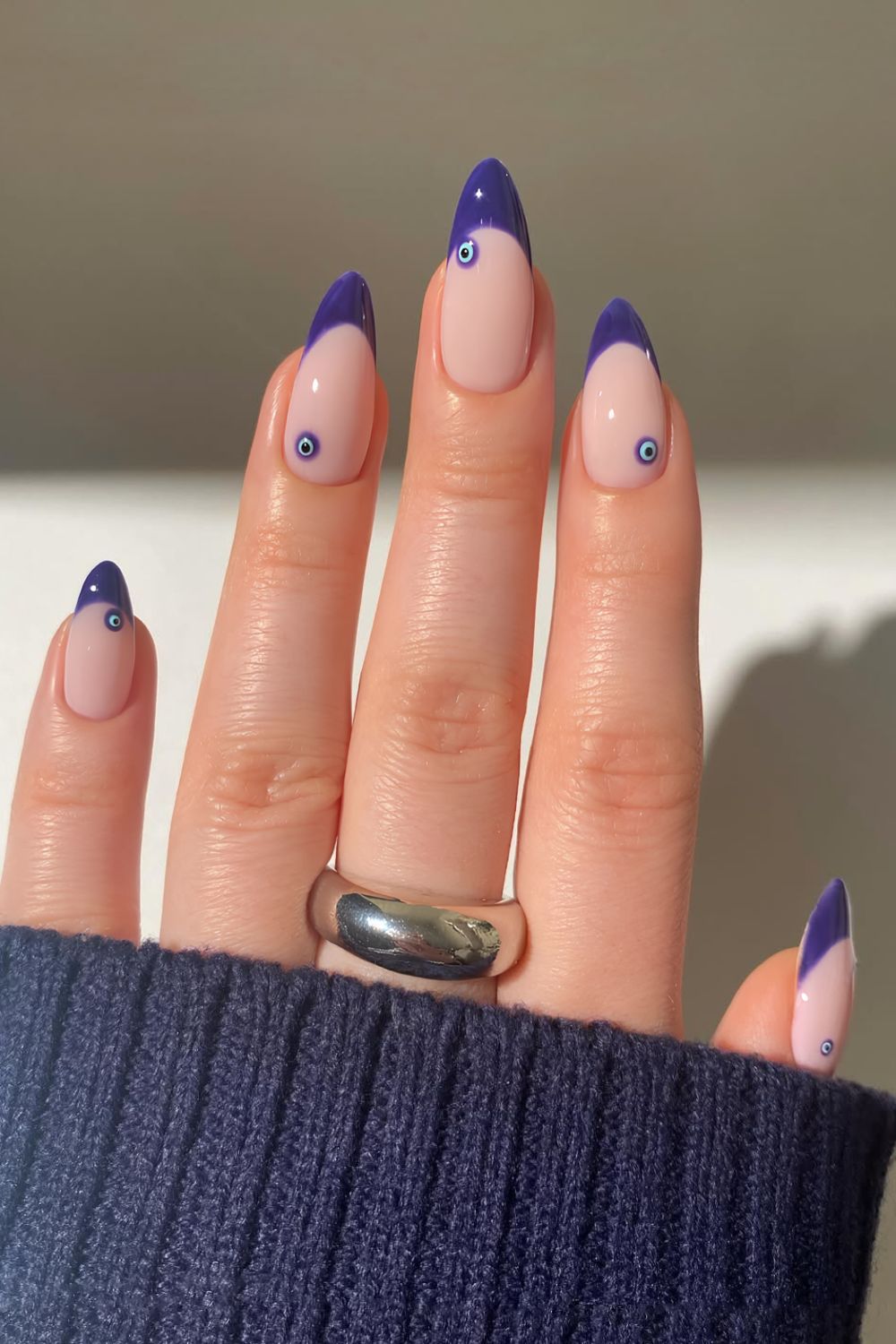 Purple French nails with evil eye accents