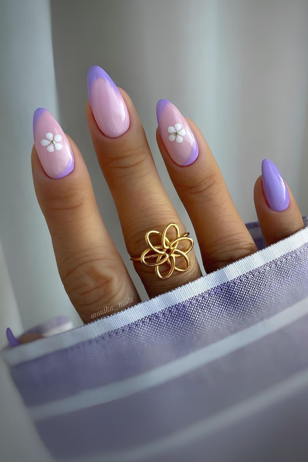 Purple French nails with soft pink base and floral accents