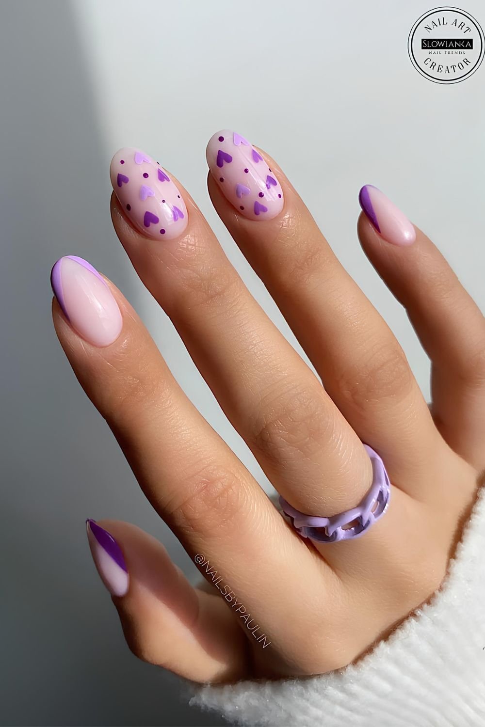 Purple and soft pink nails with tiny heart accents