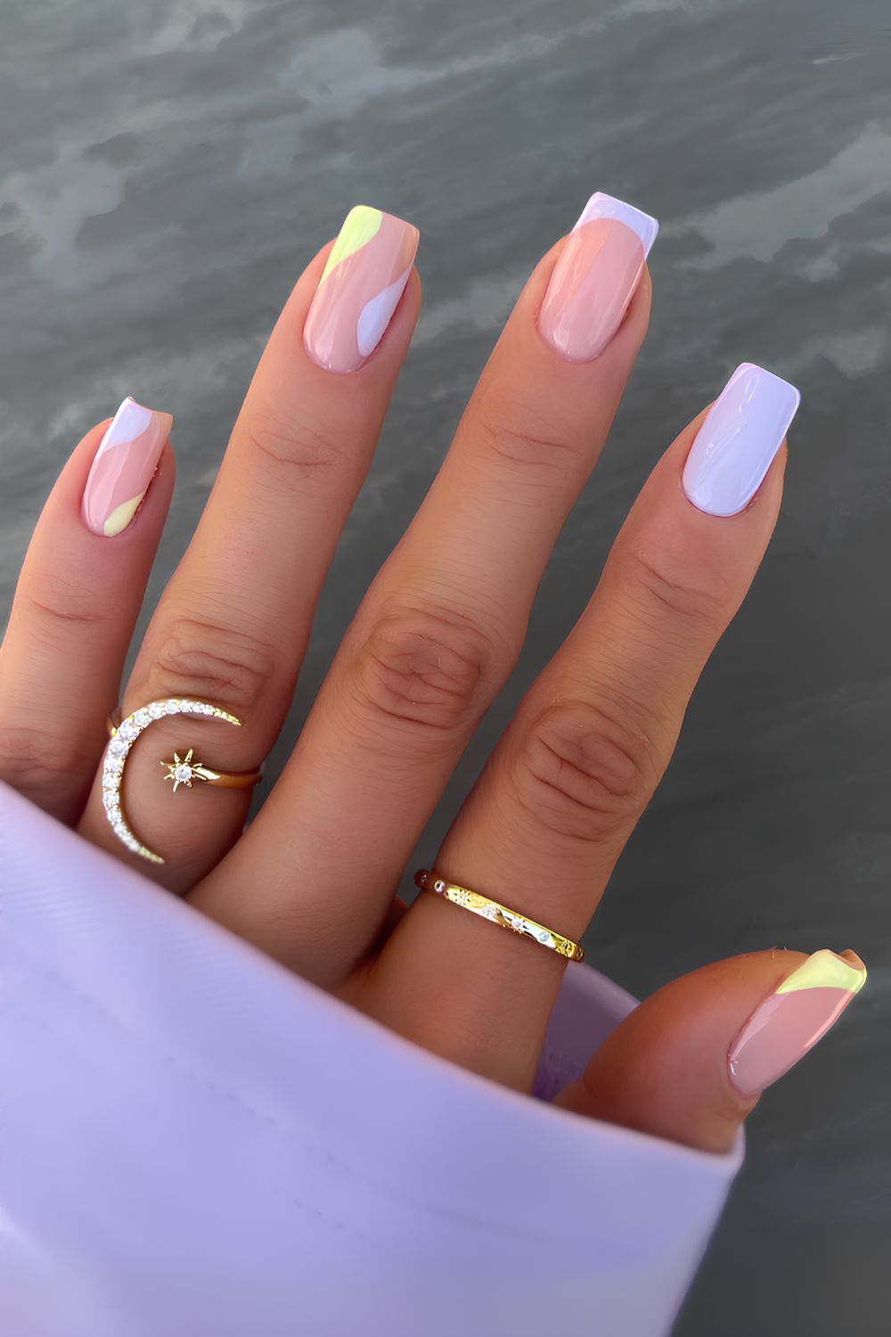 Purple and yellow nails with negative space accent