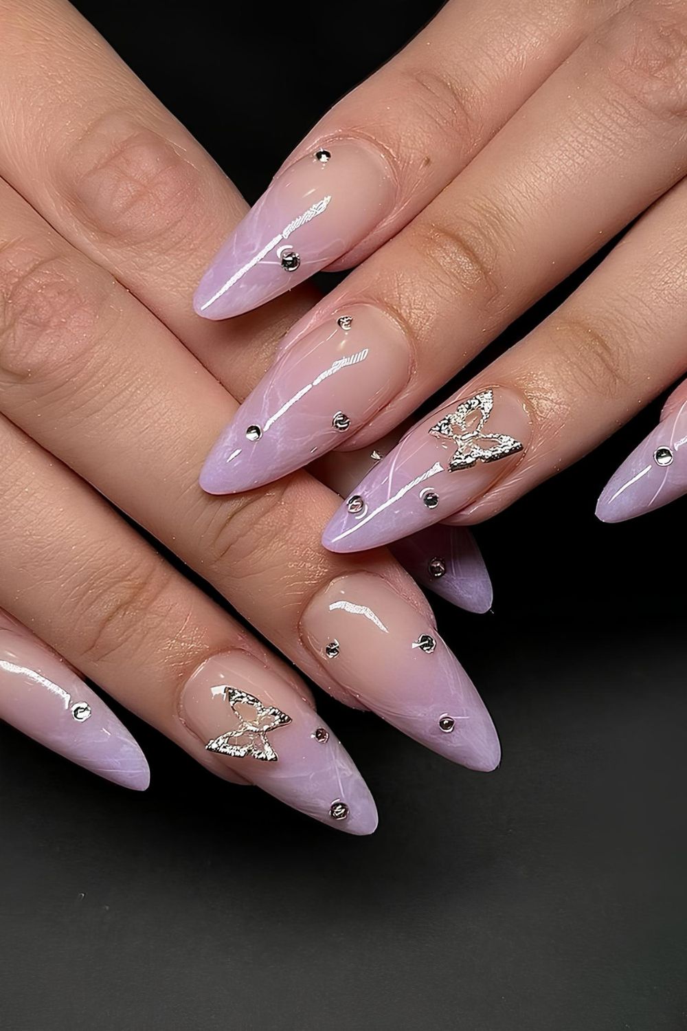 Purple marble nails with gems and butterflies