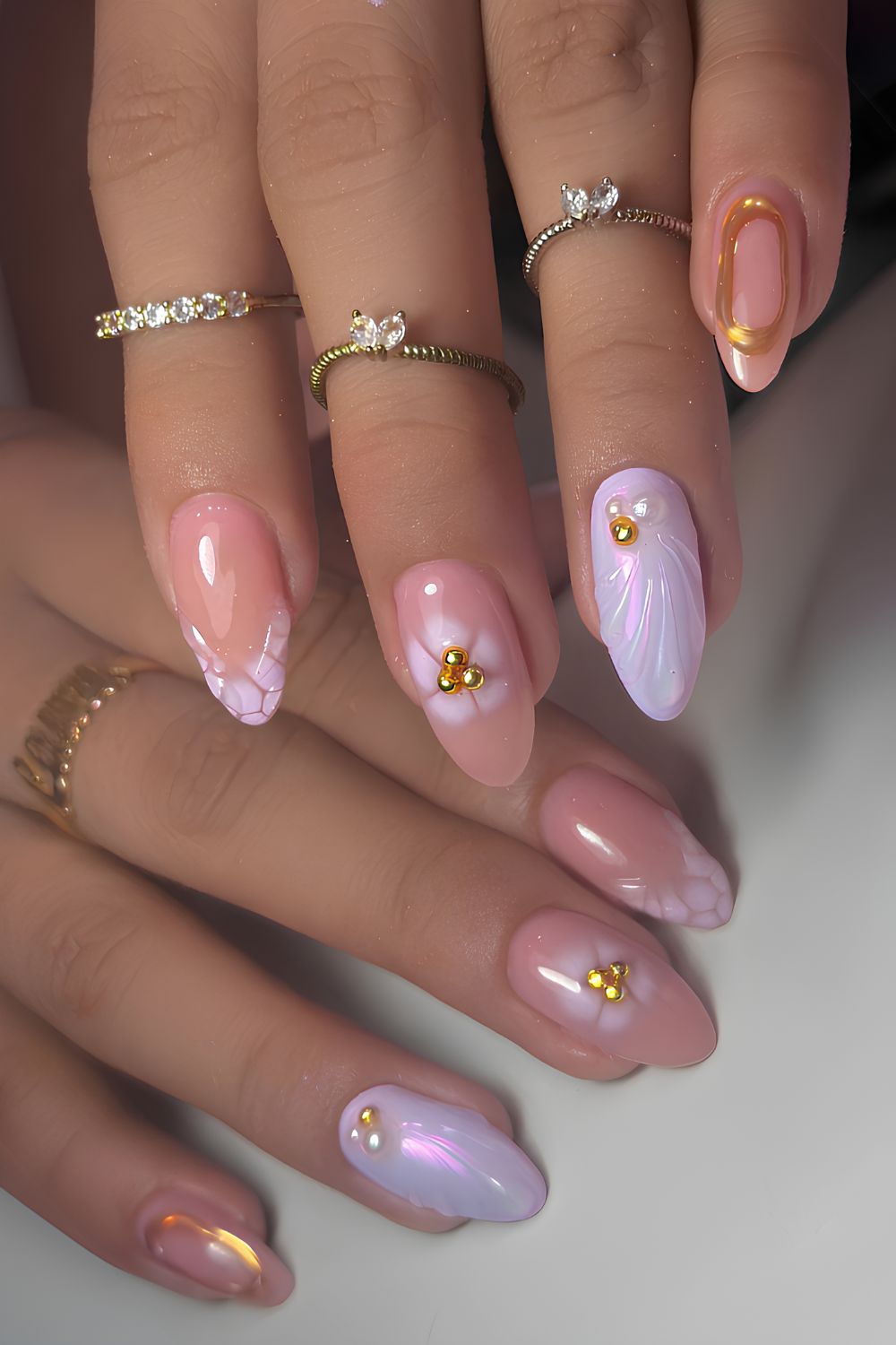 Purple nails with gold and shell accents