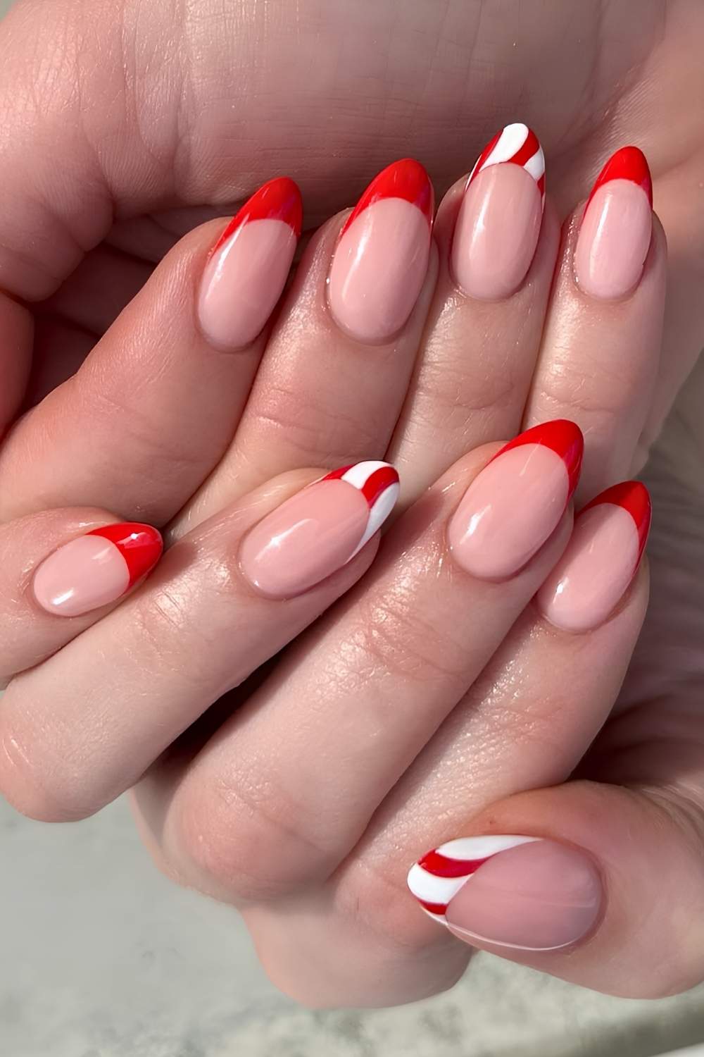 Red French mani with subtle peppermint swirl art
