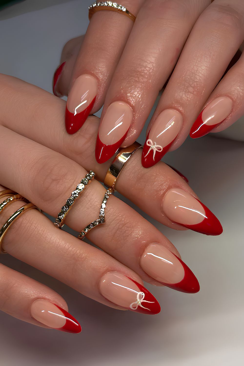 Red French mani with tiny white bows
