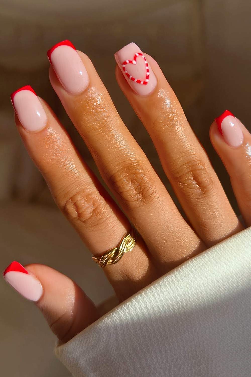 Red French manicure with candy cane heart art