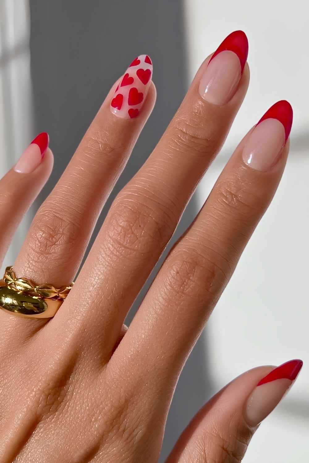 Red French manicure with stacked hearts