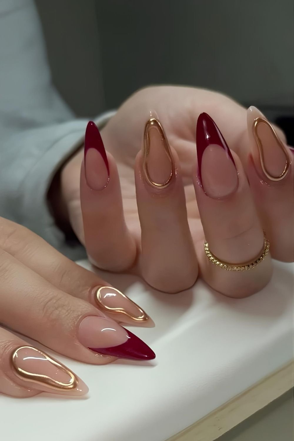 Red French nails with gold chrome accents