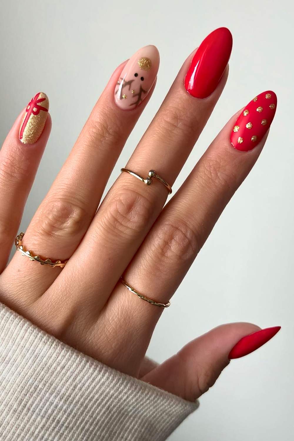 Red and gold nails with reindeer art