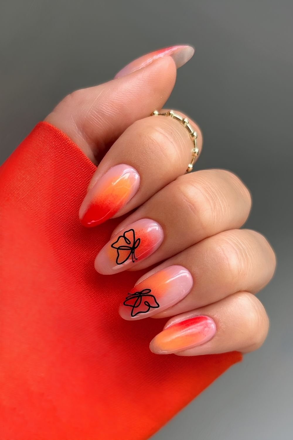 Red and orange nails with butterflies