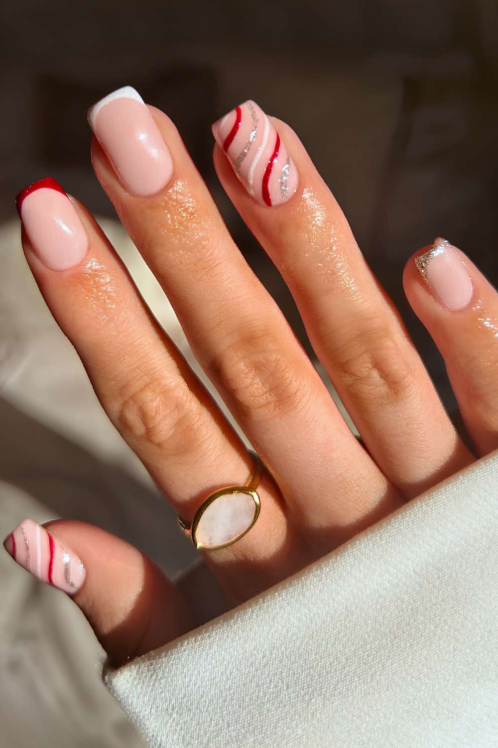Red and white French nails with festive swirls