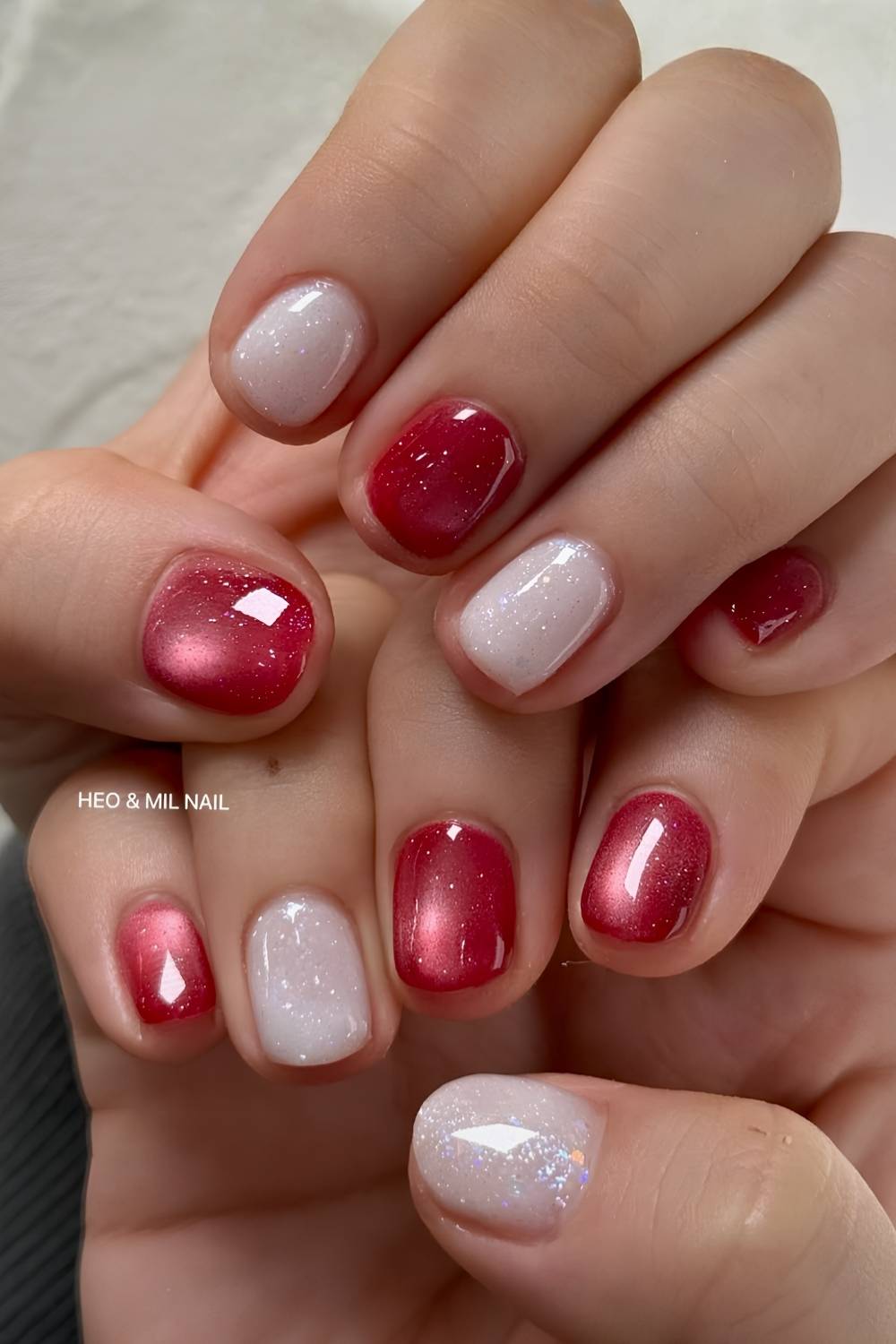 Red cat eye nails with shimmery white accents