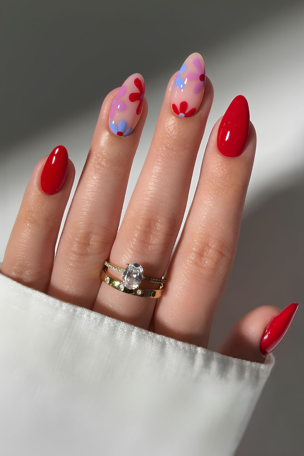 Red manicure with colorful flowers