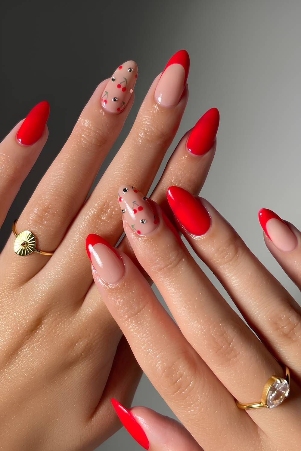 Red manicure with rhinestones and cherry art