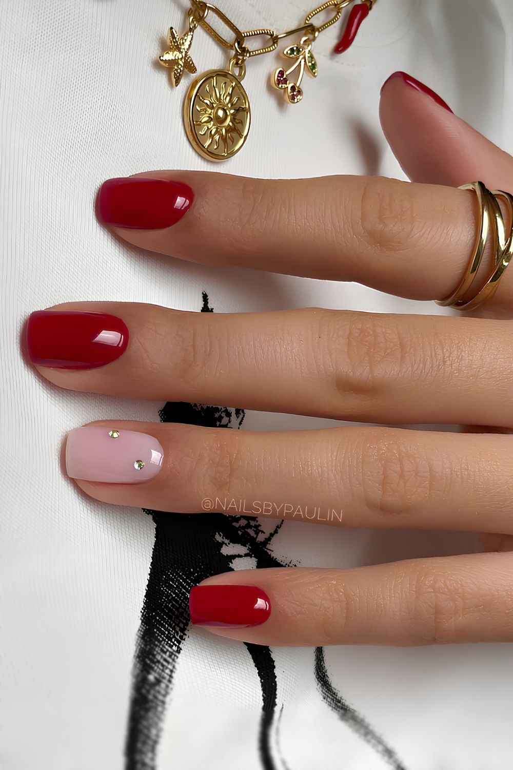 Red nails with accent rhinestones
