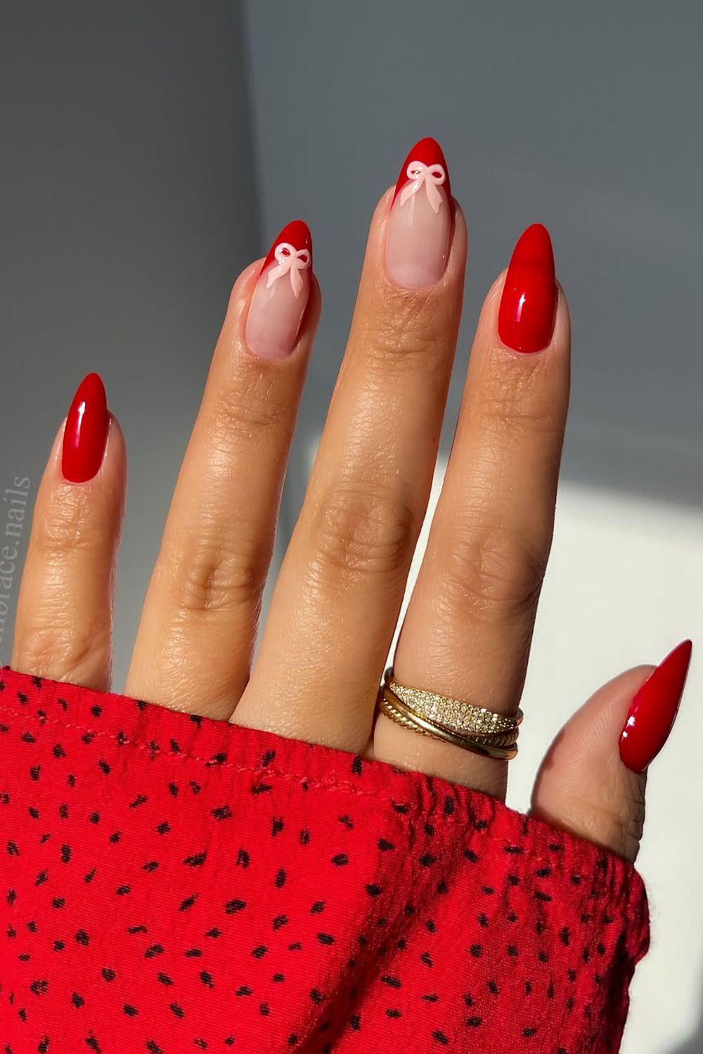 Red nails with light pink bows