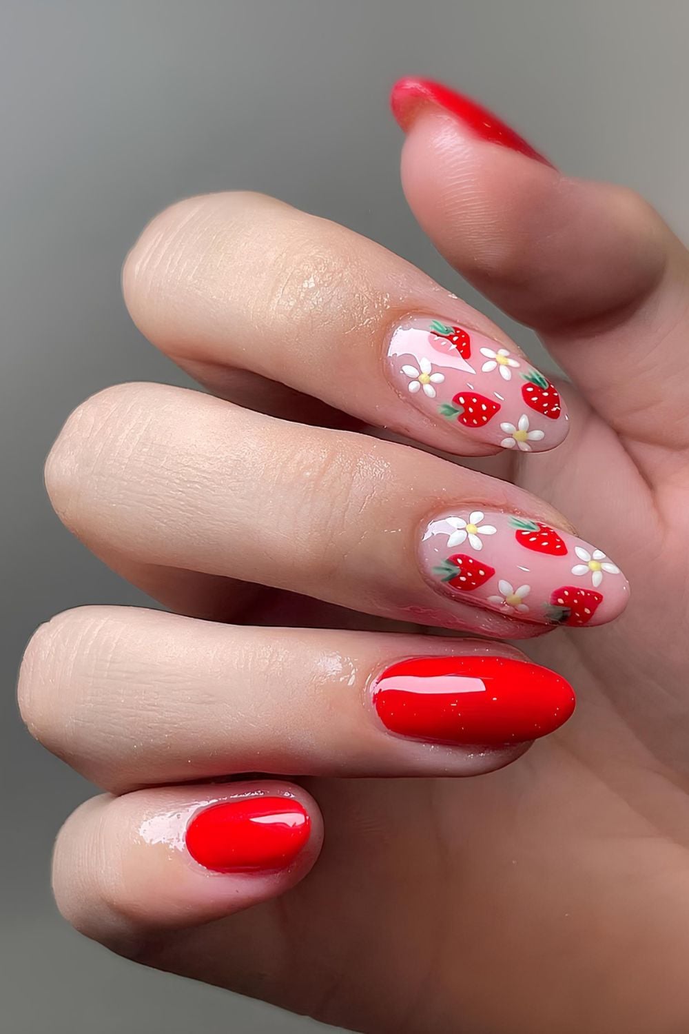 Red nails with strawberries and flowers