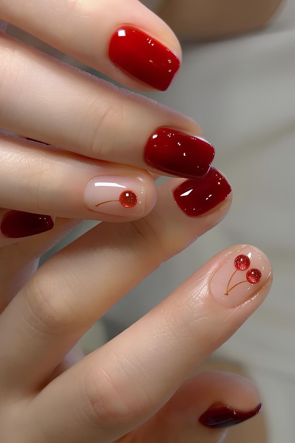 Red nails with velvet cherry accents and jelly finish