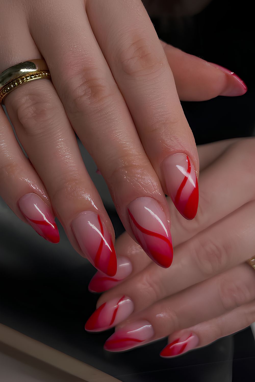 Red ombre nails with accent swirls
