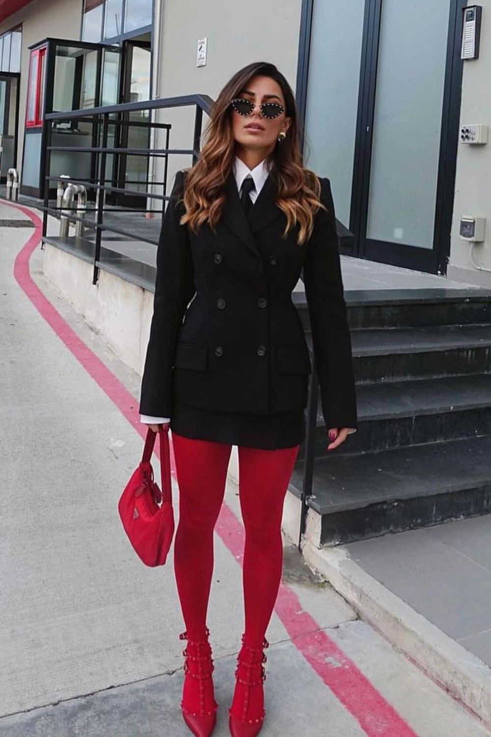Red tights, red heels, and black suit and tie