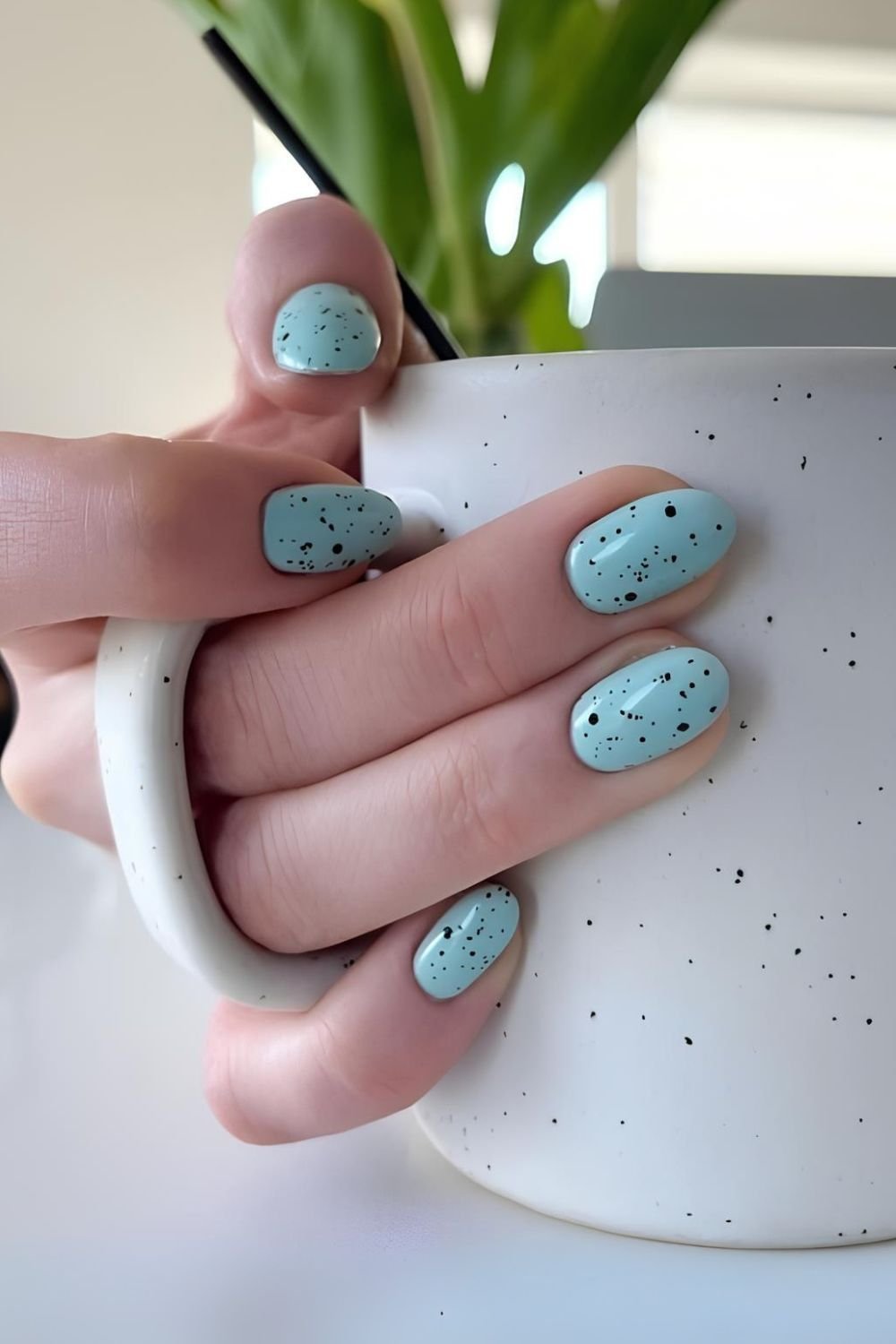 Robin’s egg blue nails with black speckles
