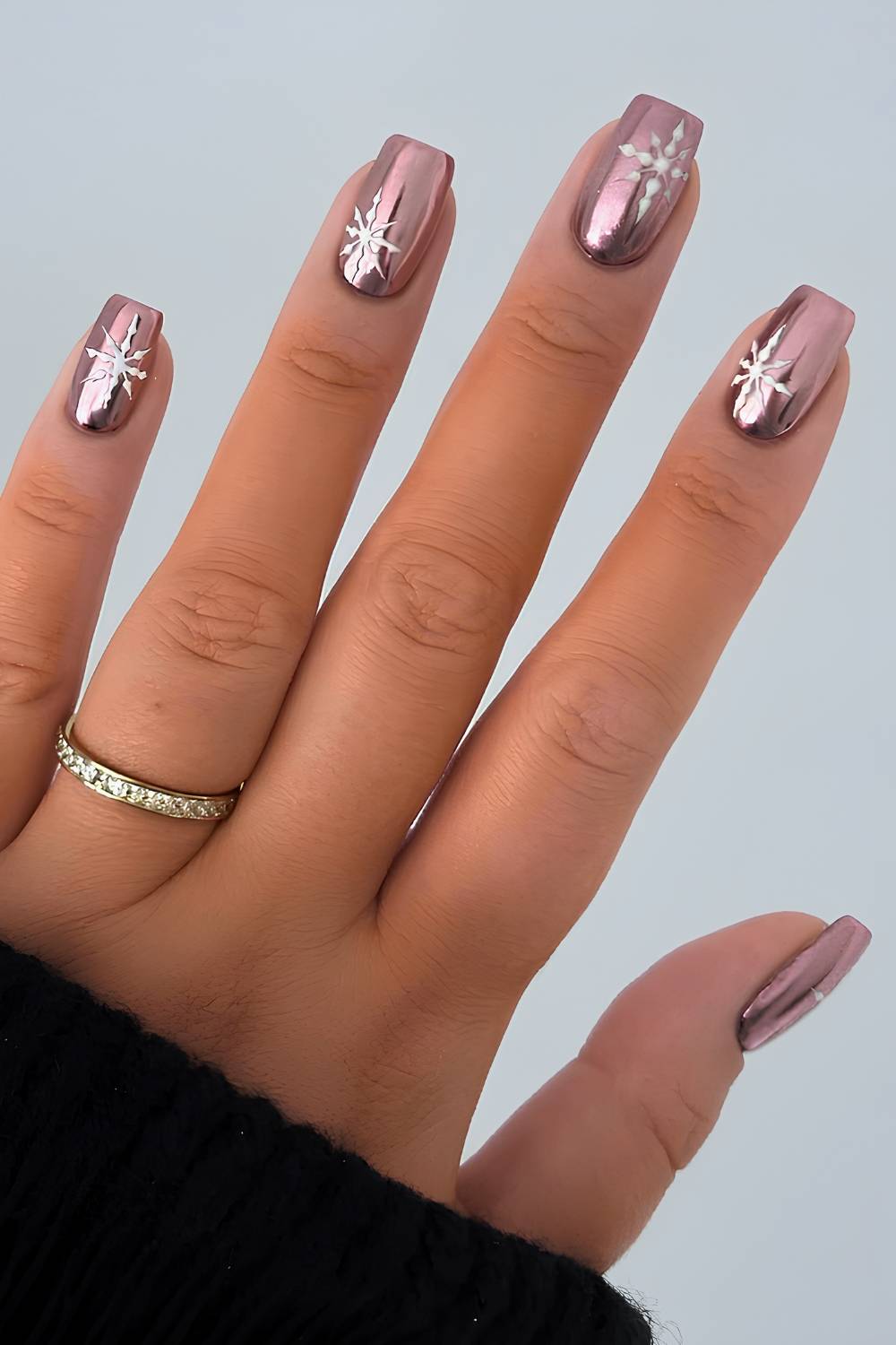 Rose gold chrome nails with snowflake art