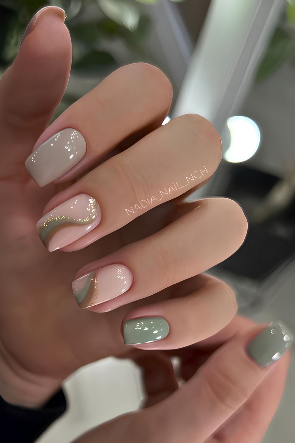 Sage green nails with swirl art